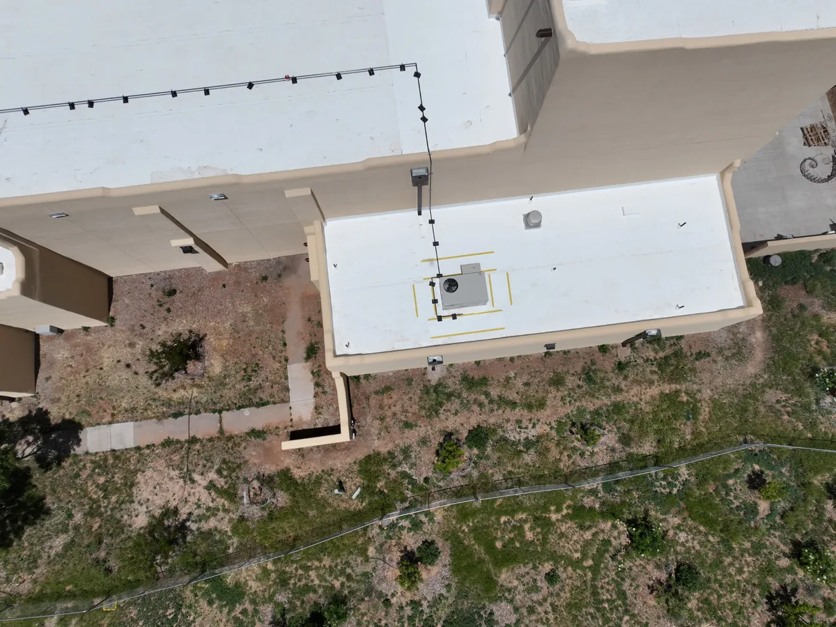 Aerial view of a white membrane coating applied to a flat roof