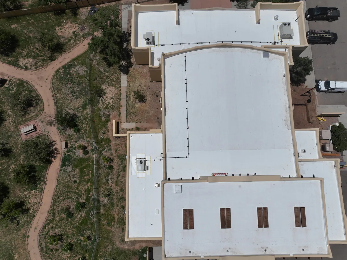 Aerial view of a white flat roof on a commercial building
